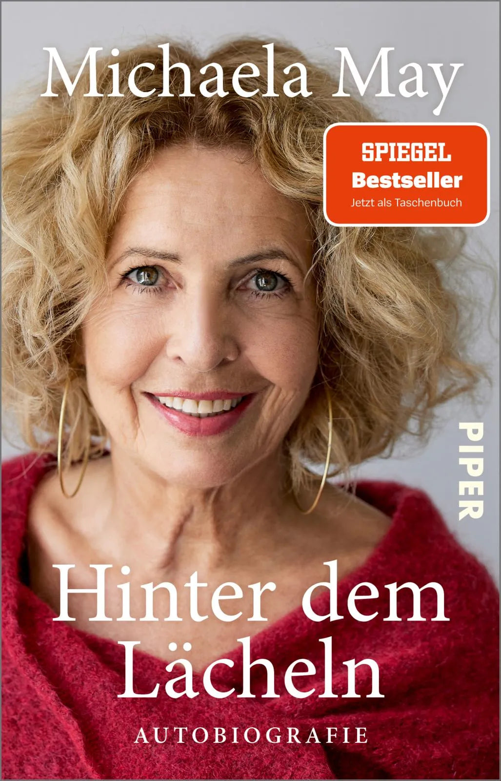 Buchcover von 'Hinter dem Lächeln' - Taschenbuch von Michaela May